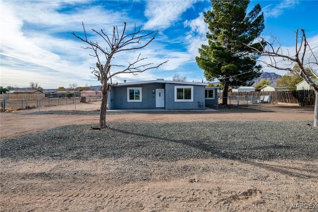 view of front of house with fence private yard and stucco siding