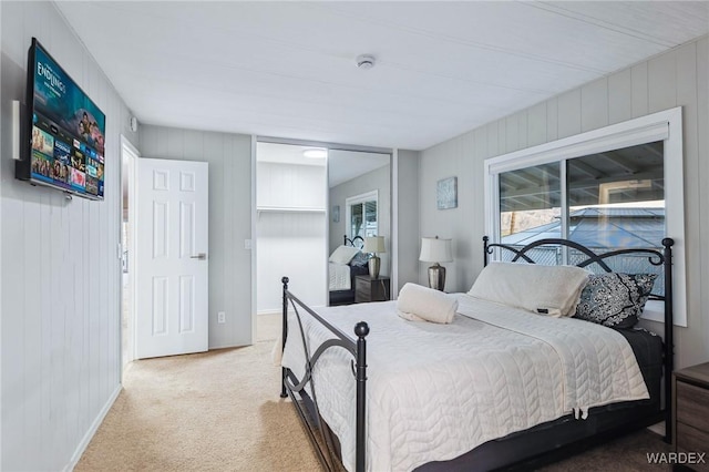 bedroom featuring carpet floors, multiple windows, and baseboards