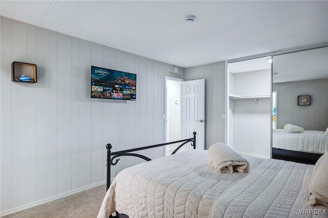 carpeted bedroom with baseboards and a closet