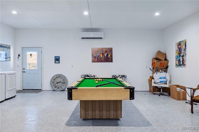 recreation room with light speckled floor, washing machine and dryer, a wall unit AC, and recessed lighting