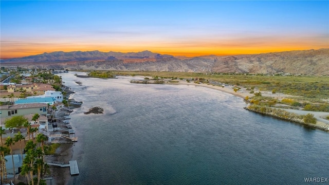 aerial view at dusk with a residential view and a water and mountain view