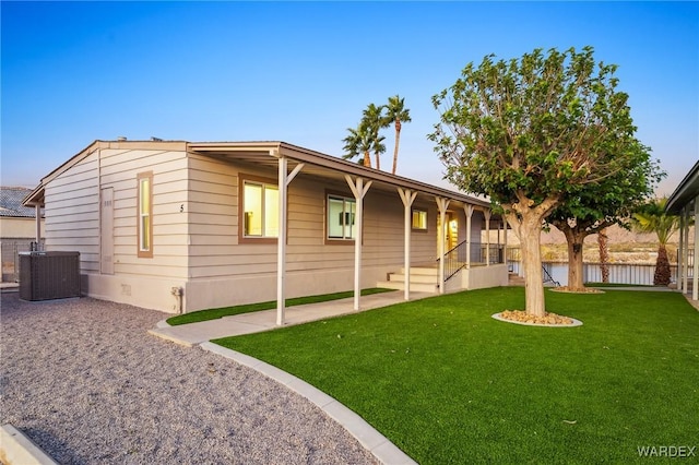 single story home with fence, a front lawn, and central AC unit