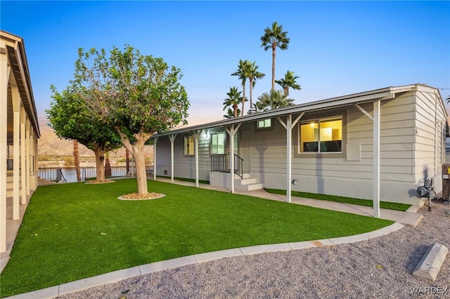 ranch-style home with fence and a front lawn