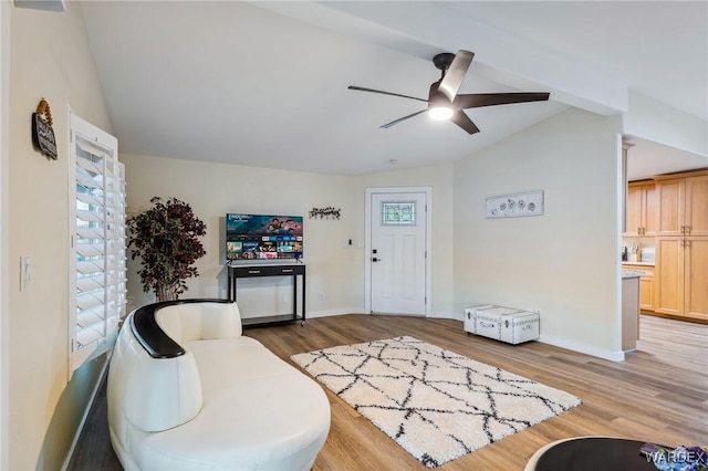 foyer featuring lofted ceiling, light wood-style floors, a healthy amount of sunlight, and a ceiling fan