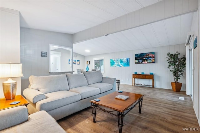 living room with lofted ceiling and wood finished floors