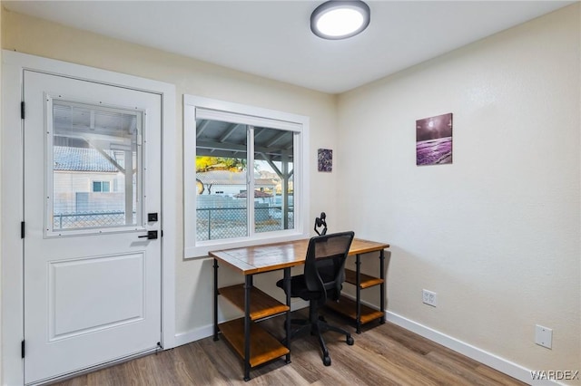 office area with baseboards and wood finished floors