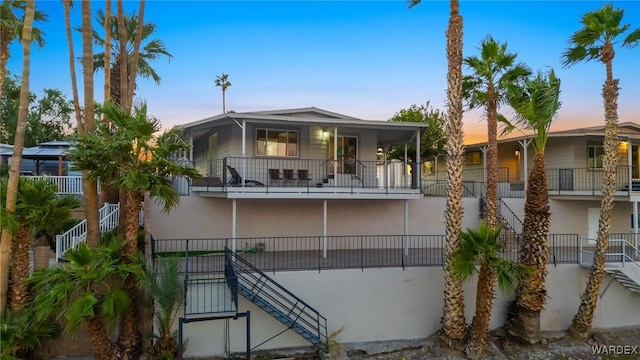 property at dusk with stairs