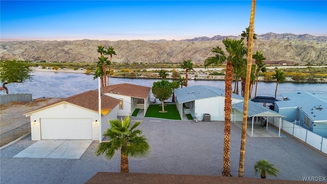 birds eye view of property with a water and mountain view