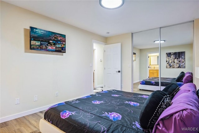 bedroom featuring baseboards and wood finished floors