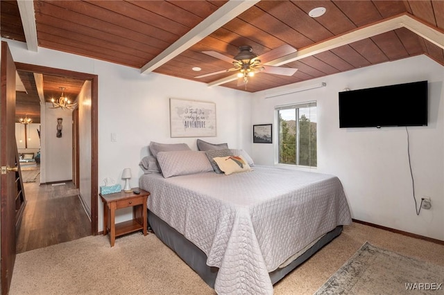 carpeted bedroom featuring baseboards, wood ceiling, ceiling fan with notable chandelier, and beam ceiling