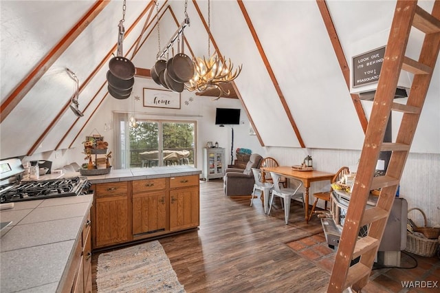 kitchen featuring lofted ceiling with beams, tile countertops, dark wood-style flooring, and brown cabinetry