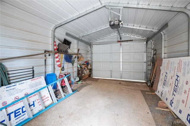 garage featuring metal wall and a garage door opener