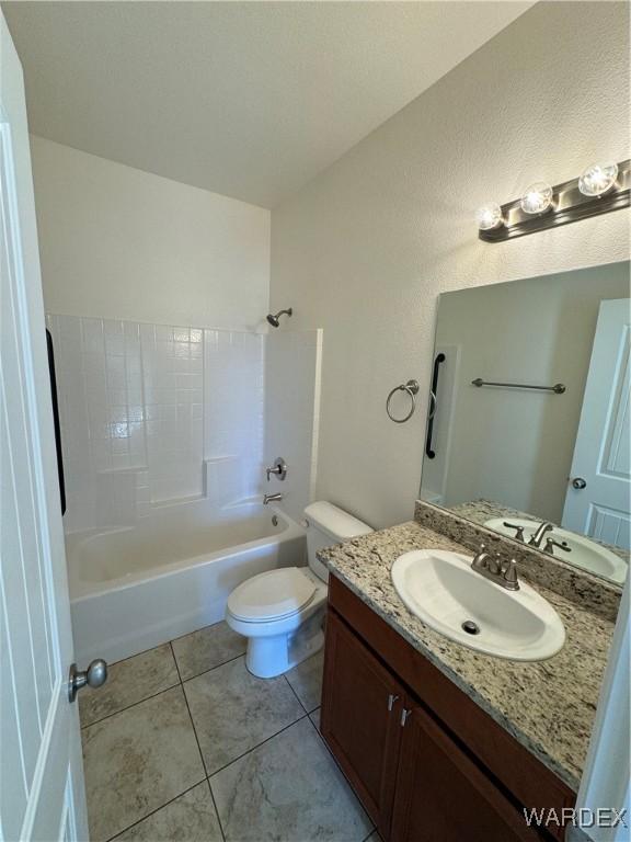 bathroom featuring toilet, tile patterned flooring, bathtub / shower combination, and vanity