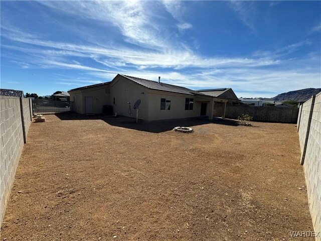 rear view of property with a fenced backyard