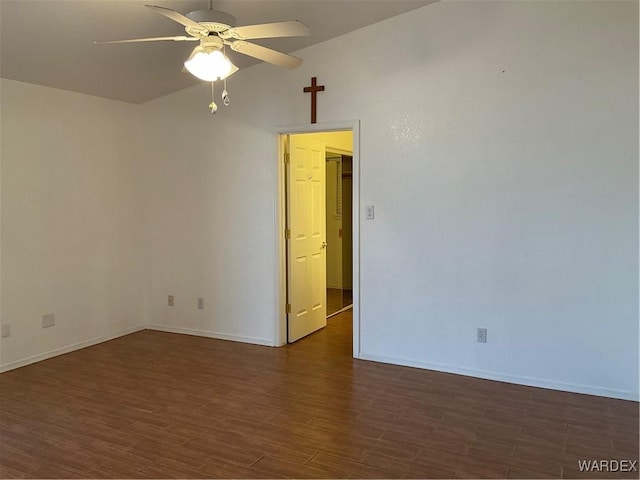 spare room featuring dark wood-style floors, baseboards, and a ceiling fan