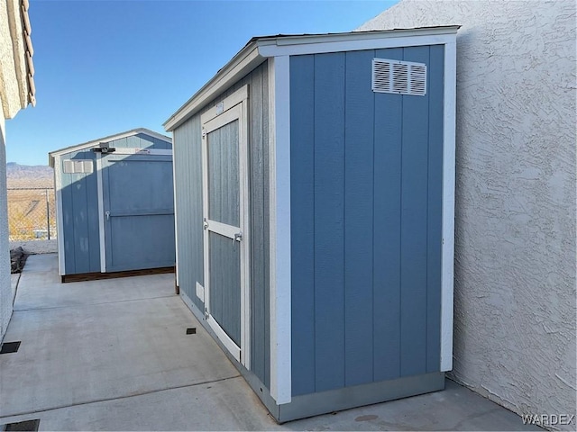 view of shed featuring fence