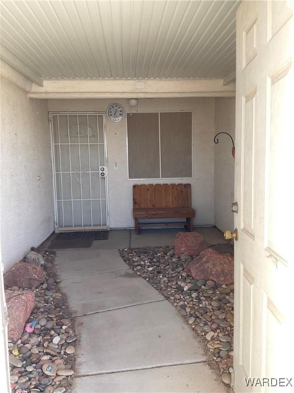 entrance to property featuring stucco siding