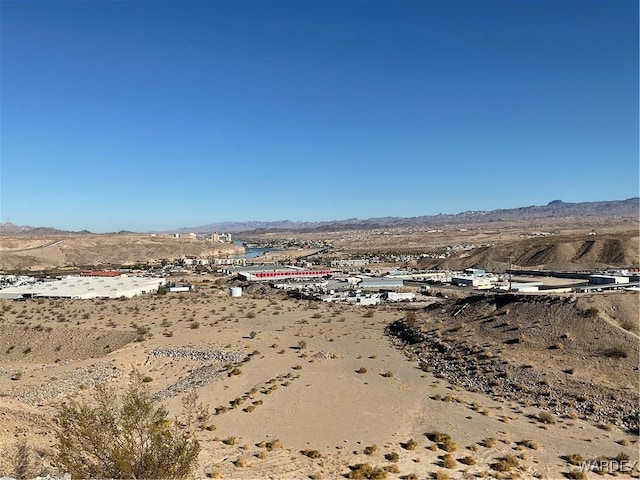 aerial view featuring a mountain view and view of desert