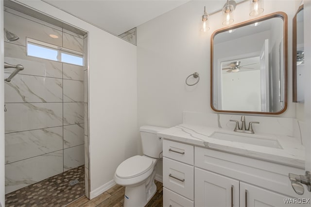 bathroom featuring a walk in shower, wood finished floors, vanity, and toilet