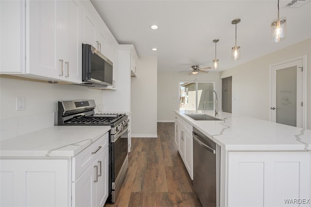 kitchen with a sink, visible vents, white cabinets, appliances with stainless steel finishes, and dark wood finished floors