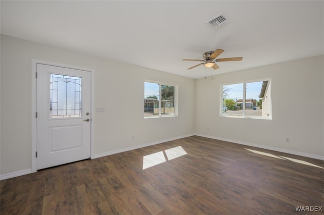 foyer featuring visible vents, ceiling fan, baseboards, and wood finished floors