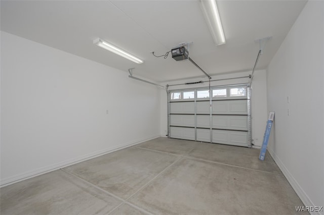 garage with a garage door opener and baseboards