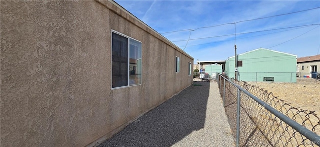 view of property exterior with fence and stucco siding