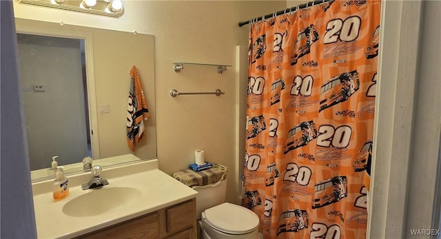 bathroom with vanity, toilet, and a shower with curtain