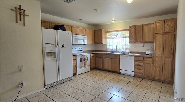 kitchen with light tile patterned floors, white appliances, a sink, visible vents, and brown cabinetry