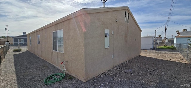 view of home's exterior with a fenced backyard and stucco siding