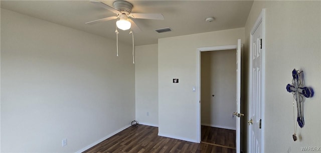 unfurnished bedroom with attic access, baseboards, visible vents, dark wood finished floors, and ceiling fan