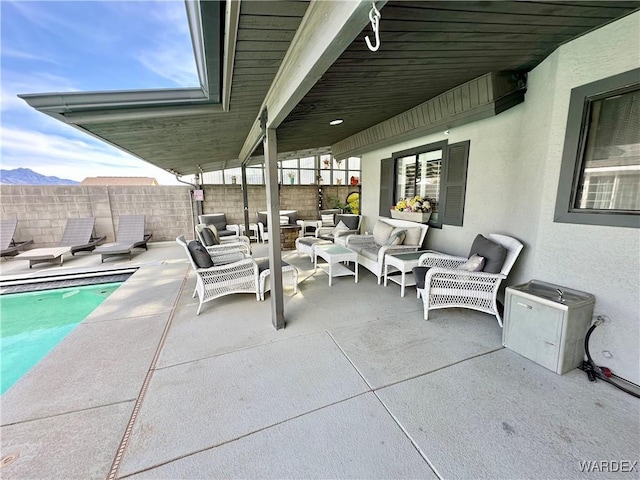 view of patio / terrace featuring fence, outdoor lounge area, and a fenced in pool