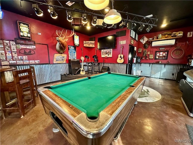 game room with concrete flooring, a wall mounted AC, and billiards