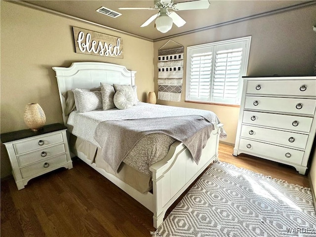 bedroom with visible vents, ceiling fan, and wood finished floors