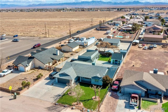 birds eye view of property with view of desert, a residential view, and a mountain view