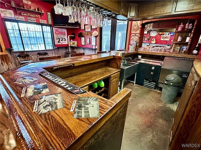 bar featuring concrete flooring and indoor wet bar