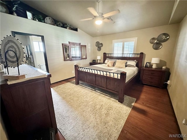 bedroom featuring a ceiling fan, lofted ceiling, visible vents, and wood finished floors