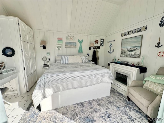 bedroom featuring vaulted ceiling, light tile patterned flooring, and wood ceiling