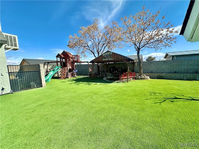 view of yard featuring a playground and a fenced backyard