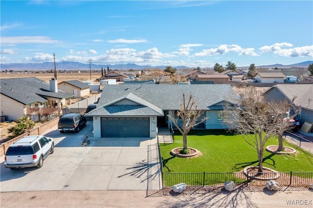 view of front of house with a front lawn, an attached garage, fence, and a residential view