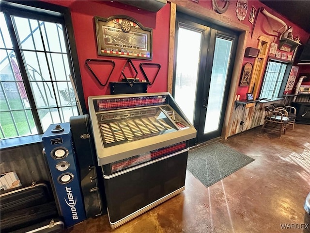 recreation room with french doors, plenty of natural light, and finished concrete flooring