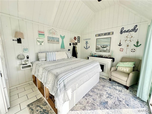 bedroom with tile patterned flooring and vaulted ceiling