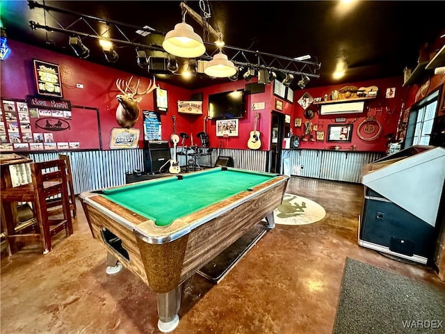 recreation room featuring an AC wall unit, concrete floors, and billiards