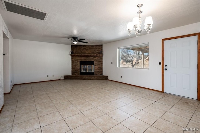 unfurnished living room featuring visible vents, ceiling fan with notable chandelier, a fireplace, and a textured ceiling