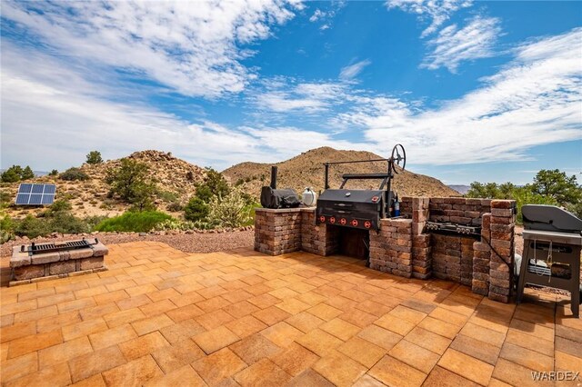 view of patio with a grill and a mountain view