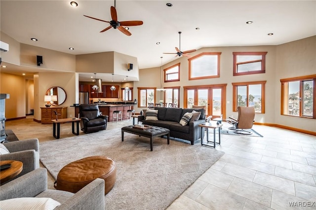 living room featuring baseboards, a ceiling fan, light tile patterned flooring, high vaulted ceiling, and recessed lighting