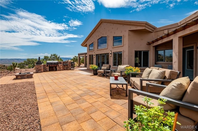 view of patio with area for grilling and an outdoor living space