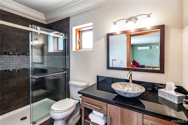 full bathroom with toilet, ornamental molding, vanity, a shower stall, and a wall mounted AC