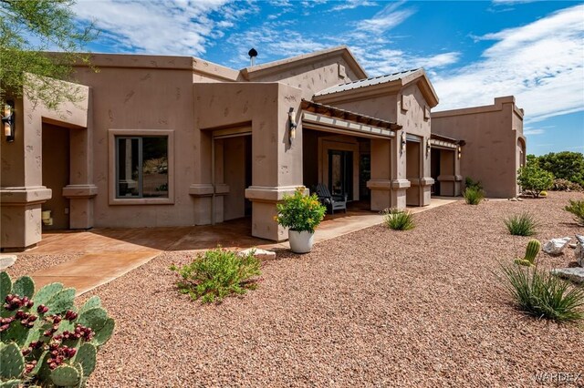 back of house featuring a patio area and stucco siding