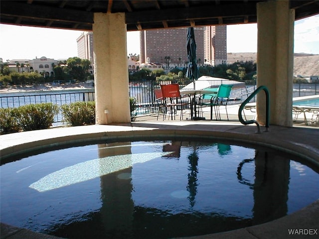 community pool with fence and a patio area